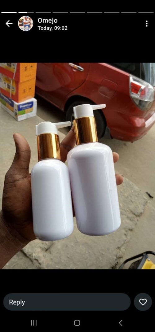 WHITE PLASTIC BOTTLE WITH A GOLD PUMP DISPENSER