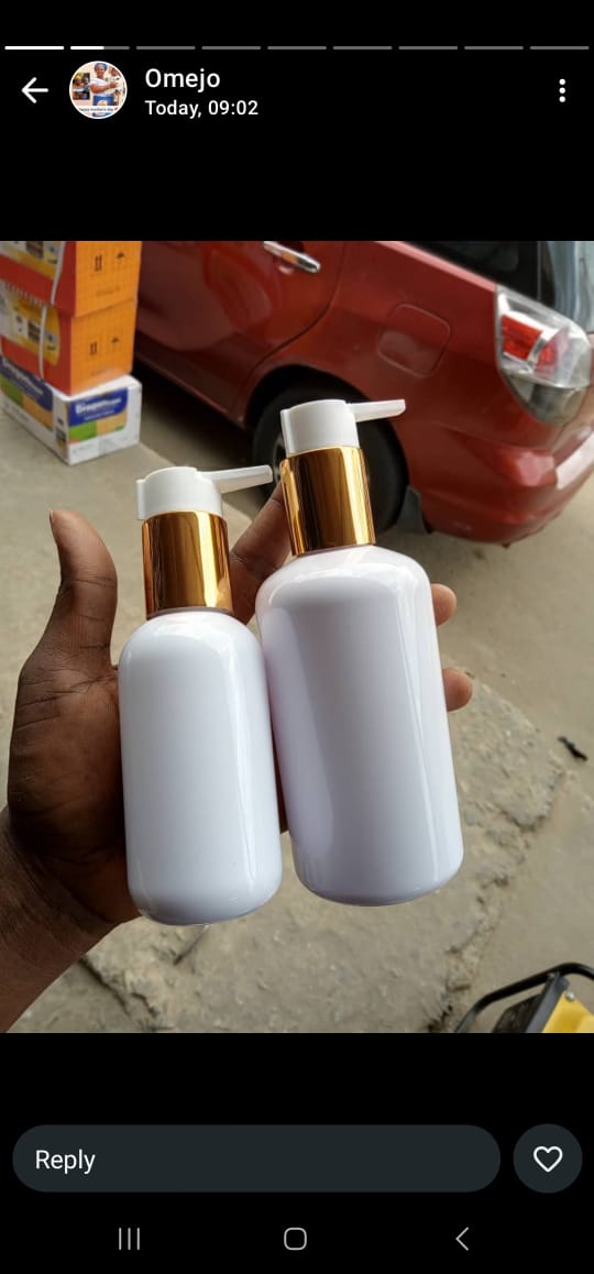 WHITE PLASTIC BOTTLE WITH A GOLD PUMP DISPENSER